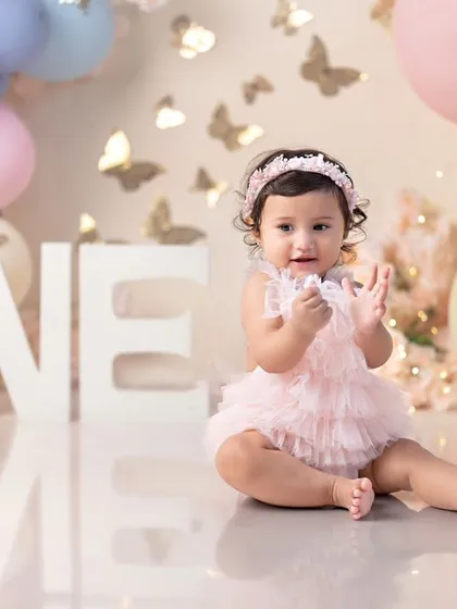 A beautiful butterfly-themed first birthday, with this little one clapping her hands in delight.