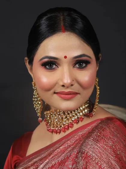 This is a timeless look for a reception or traditional function. I paired a classic red saree with glowing skin, a sharp winged eyeliner, a red bindi, and a soft red lip for an elegant and sophisticated finish.