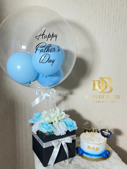 A charming Father's Day combo with a bento cake, a floral box arrangement, and a personalized balloon.