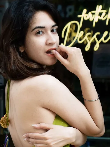 A playful and alluring portrait with a neon sign in the background. Using elements of the location's decor, like this sign, adds character and context to the photos.