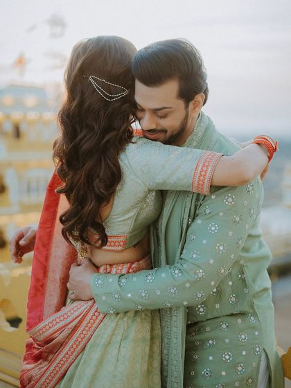 A heartfelt hug between the bride and groom, capturing a quiet moment of connection.