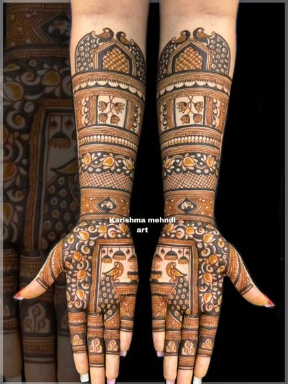 A classic bridal design featuring peacocks on the palms and traditional leaf motifs on the arms. The intricate patterns and clean execution make this a timeless choice for any bride.