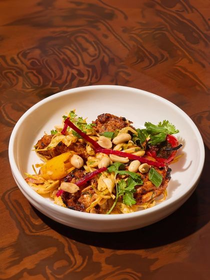 This dish is all about the pepper. Grilled chicken tikka is tossed with three kinds of pepper, pickled veggies, peanuts, and herbs for a dish that has crunch, heat, and flavour.