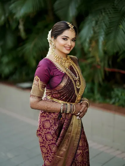 Shloka's smile says it all. Her confidence shines through, amplified by a makeup look that feels both regal and comfortable, celebrating her South Indian heritage with grace.