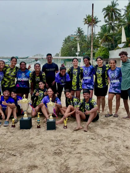 A candid shot of our team celebrating on the beach with multiple trophies, a perfect end to a successful tournament.