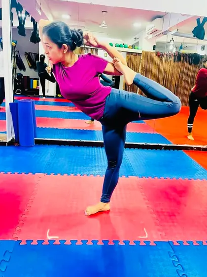 This student holds a strong and graceful Natarajasana, showing the balance and focus required for this beautiful standing pose.