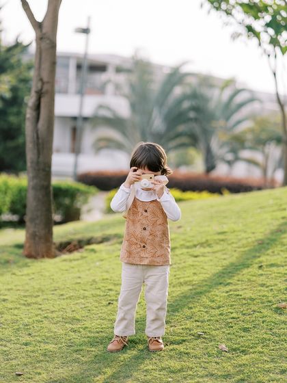 A little boy playing photographer with a toy camera. It's fun to see the world through their eyes.