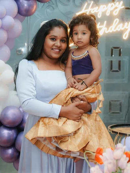 Another example of my mother-daughter matching sets, this time blending traditional and contemporary styles. The daughter wears a custom kids' lehenga choli with a rich gold pattu skirt and a modern velvet top, coordinated with her mother's elegant gown.