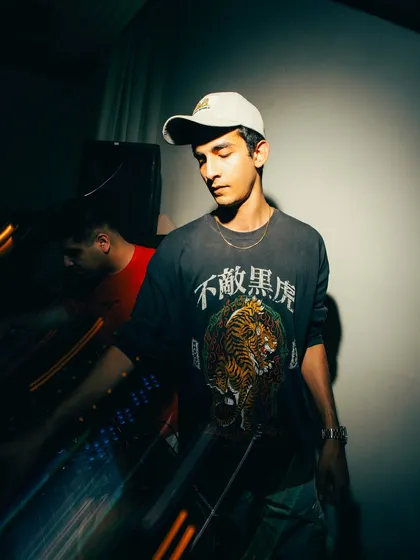 A moody, artistic shot of me at the decks. As an open-format DJ with 9 years of experience, I am constantly evolving my sound and pushing creative boundaries.