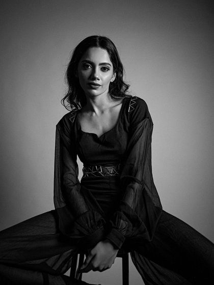 A direct gaze in this black and white shot. The eyes are the focal point, defined with soft, smoky makeup.