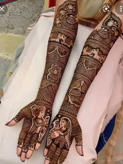A divine Radha-Krishna design for a client who wanted something spiritual. The full-arm work includes the deities, elephants, lotus flowers, and a sacred kalash pot.