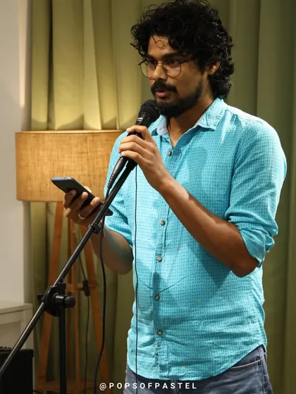 A performer reads from his phone, a modern take on poetry and storytelling.