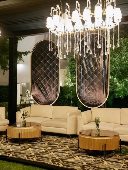 Another angle of the sophisticated lounge seating, showcasing the blend of modern furniture and glamorous lighting.