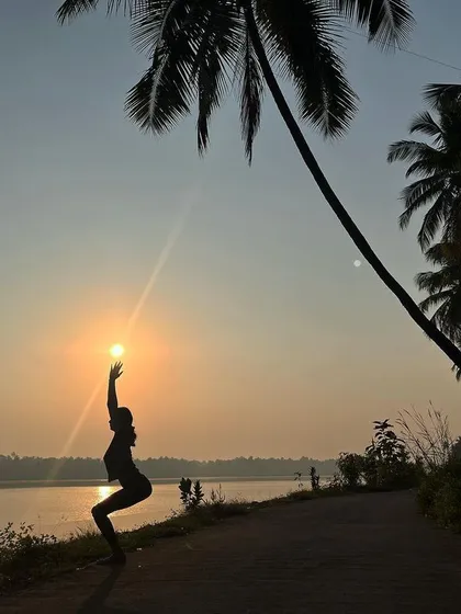 Finding strength and stillness in Utkatasana, or Chair Pose, against a beautiful sunset. This pose is a great way to build heat in the body while strengthening your core, thighs, and ankles.