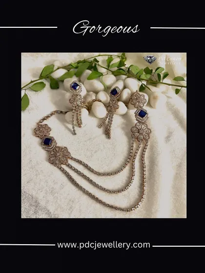 A gorgeous layered diamond necklace with blue stone accents. This piece is perfect for creating a sophisticated and stylish look for an evening event.