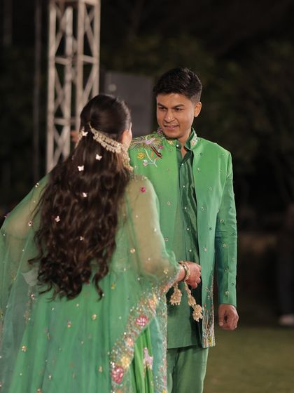 A candid shot of the couple, showing how the butterfly-adorned hairstyle looks from a distance. It adds a playful and magical touch to the bride's overall look.