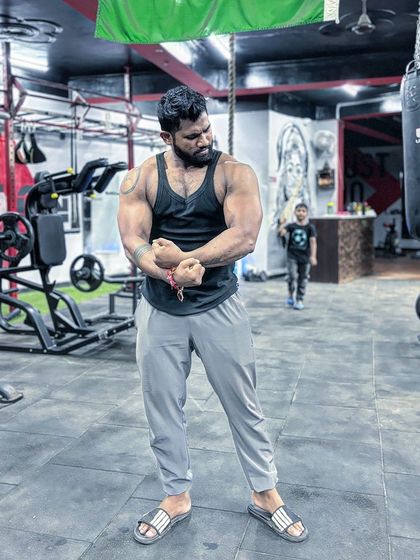 Professional in the gym, personal outside. A full-body pose showing the physique I've built.