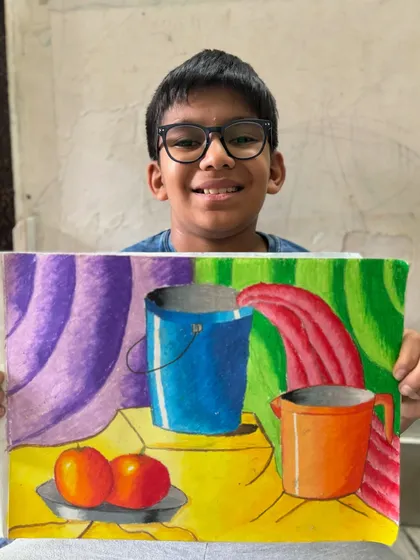 Still life drawing is a fundamental skill that I teach to help students understand form, shading, and composition. This colourful piece by a 6th-grade student shows a wonderful grasp of these core concepts.
