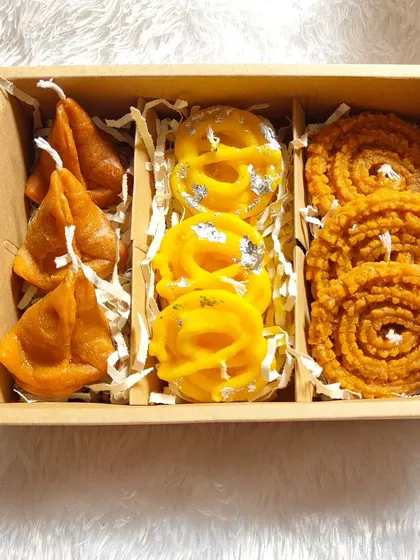 Another one of my Indian sweet-themed candle boxes. This one contains candles shaped like samosas, jalebis, and chaklis, all handmade from soy wax.