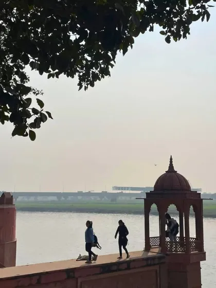 A quiet moment of reflection by the Yamuna river near Agra. This is the serene end to a day of cycling, watching the river flow by historic monuments.