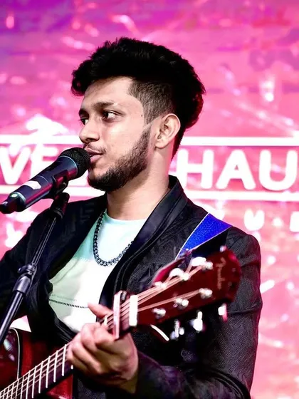Here I am with my guitar, backed by the full band. This setup allows us to cover a wide range of genres, from rock-infused Bollywood tracks to intricate Sufi arrangements.
