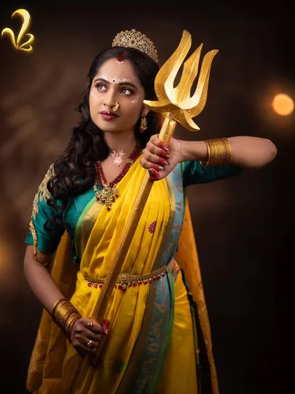 Chandrakantha holding a trishul, a symbol of her fierce protective nature. This powerful styling shows that a woman can be both a partner and a warrior, embracing her own strength.