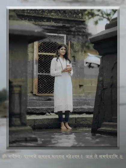 Standing barefoot in the temple courtyard, this shot captures the serene and grounded feeling of devotion during our Shravan-themed portrait session.