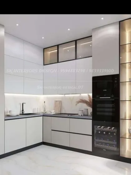A high-end kitchen design with white cabinets, a built-in oven tower, and a dedicated wine cooler. The tall, glass-fronted pantry with internal lighting is perfect for display and storage.