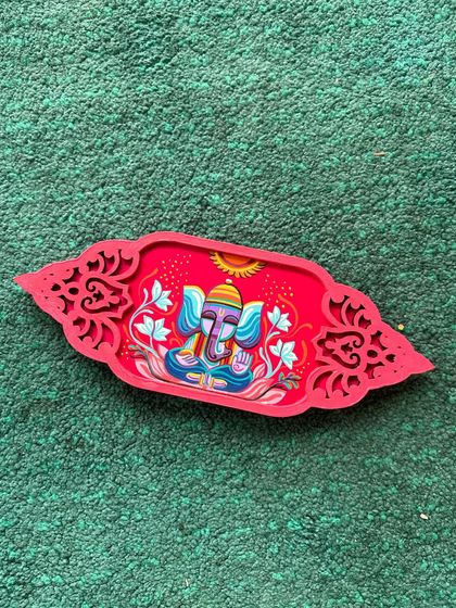 A vibrant, hand-painted Ganesha tray, perfect for holding offerings or as a decorative piece during the festival.