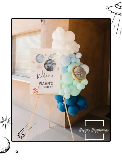 A soft and dreamy welcome sign for Viaan's "3rd trip around the sun." The pastel colors and watercolor-style graphics create a gentle and sweet introduction to the space-themed party.