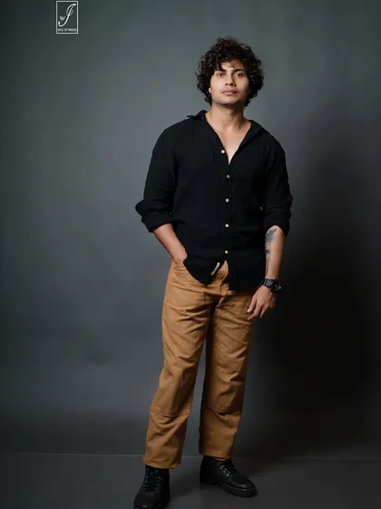 A classic male model portfolio shot. The focus here is on a clean, direct look with simple styling, allowing the model's features and confident expression to take center stage. We use precise studio lighting to create this sharp, professional result.