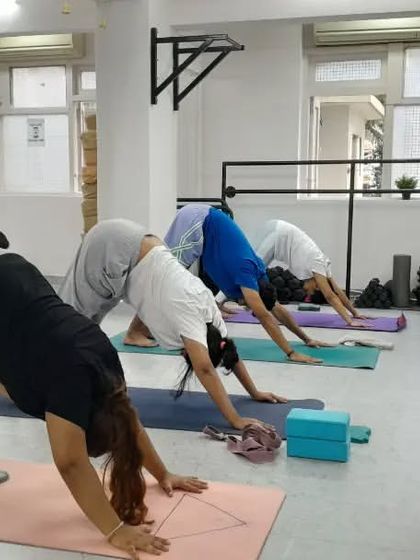 Adho Mukha Svanasana (Downward-Facing Dog) is a cornerstone of our practice, serving as both a strengthening pose and a restorative stretch.