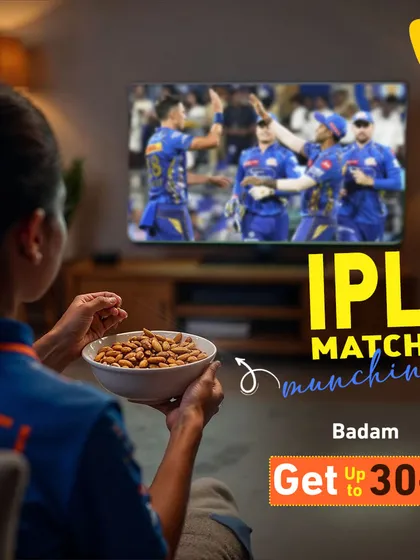 Watching the match? You need good snacks, boss. Grab a bowl of my premium almonds and make the game even better. Here's a shot of someone enjoying the IPL match with a bowl of our crunchy badam.