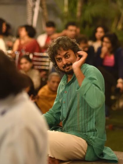 A candid moment, listening to the main artist during a performance at The Courtyard.