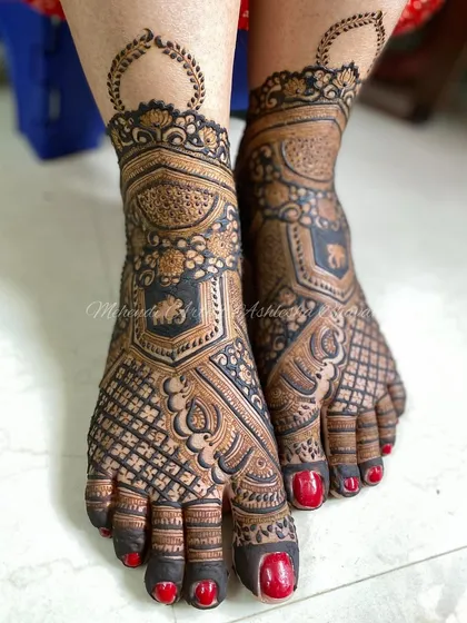 A close-up of the bridal feet design, showing the detailed elephant motifs and the intricate patterns covering the feet.