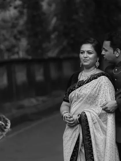 A candid black and white shot capturing a moment of street life during the couple's outdoor shoot. This adds a unique, photojournalistic element to their wedding story.