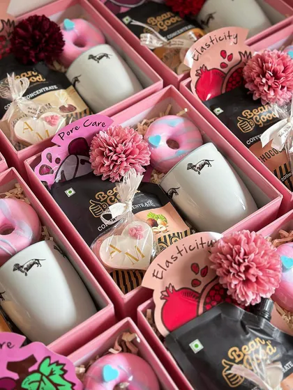 A look inside the baby shower return favors. This version includes a cute dog-themed mug, coffee concentrate, a custom cookie, and a donut soap.