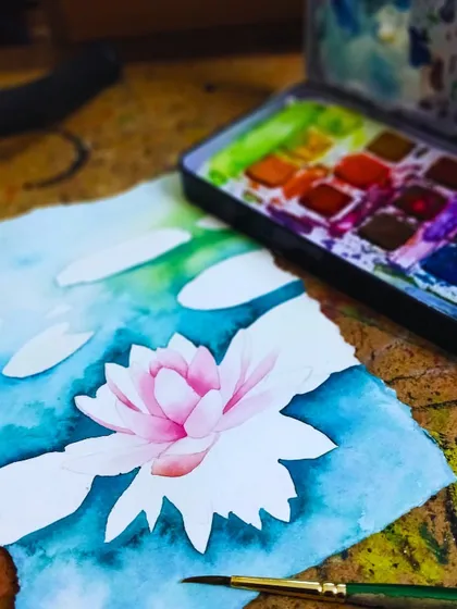 A work-in-progress of a water lily painting, showing how to use negative space and layering in watercolors.