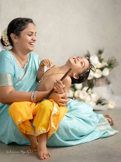 A playful moment between a mother and her little Krishna. The laughter and joy are what make these sessions so special.