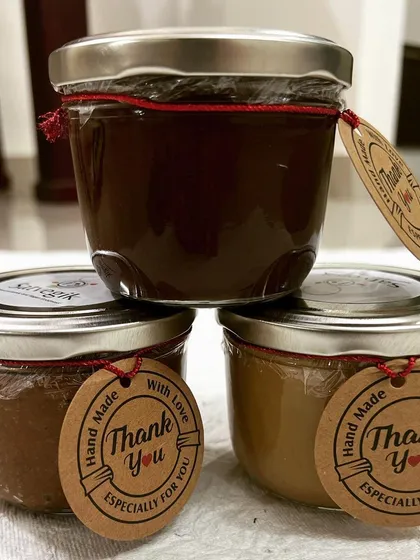 My handcrafted nut butters are pure and simple. This stack shows my healthy hazelnut nutella, almond butter, and peanut butter, all made in-house with no added sugar, oil, or preservatives. The "Hand Made With Love" tag says it all.