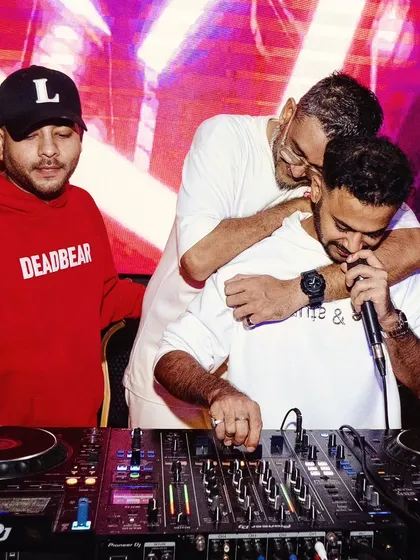 A candid moment of camaraderie behind the decks at Toy Room. I often collaborate with other talented artists to bring even more energy to my shows.