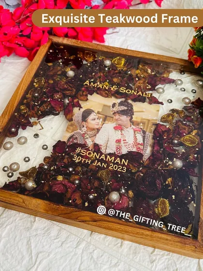 A clear shot of the frame, showing the beautiful contrast between the dark wood and the vibrant flowers.