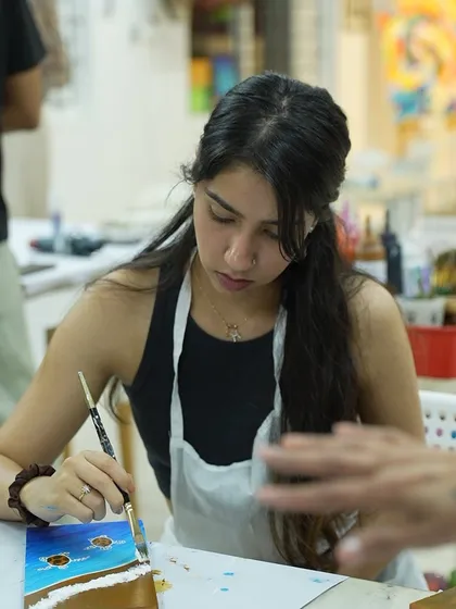 A participant engrossed in her painting. The studio is a place where you can switch off from the world and focus on your creativity.