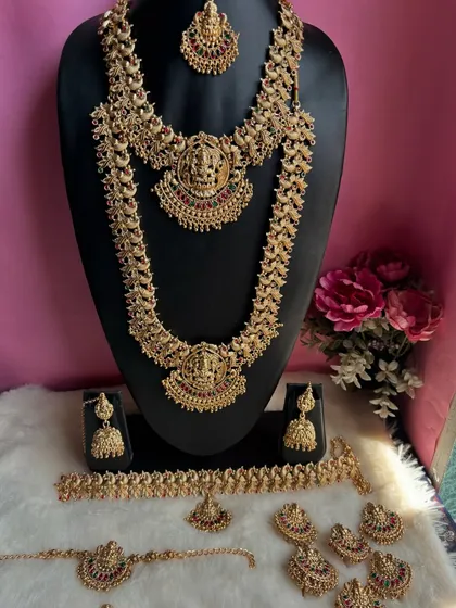 This is one of our most loved South Indian temple jewellery sets, perfect for a traditional bridal look. The complete set includes a choker, a long haram, matching jhumkas, a maang tikka, and other accessories to make you feel like a goddess.