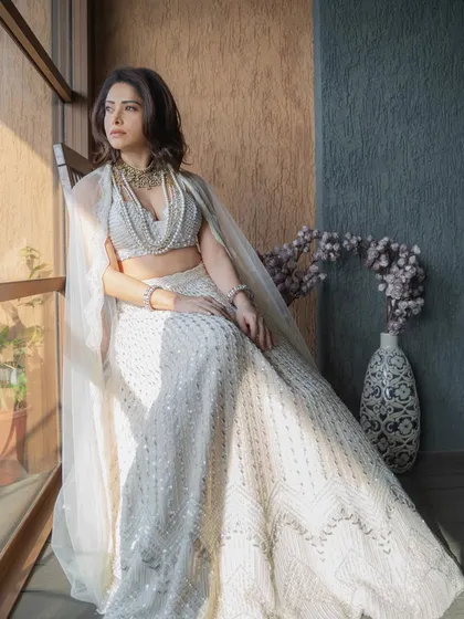 I styled Nushrratt Bharuccha in this ethereal ivory lehenga by Disha Patil for a wedding. The layered pearl necklaces add a touch of modern royalty, making it a standout look for a wedding guest.
