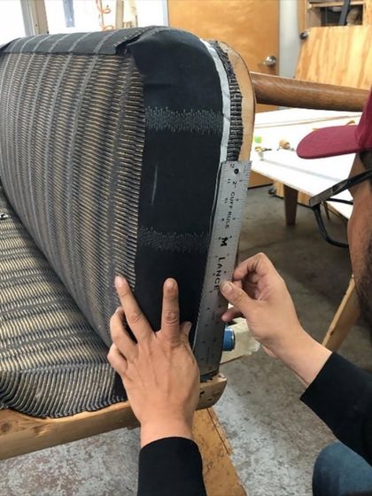 This mid-century modern settee is beautifully upholstered in our hand-printed linen. The 'Sonoma' pattern in Glitter Graphite, designed by Seema Krish, creates a unique texture with its striking yet muted metallic gold on black.