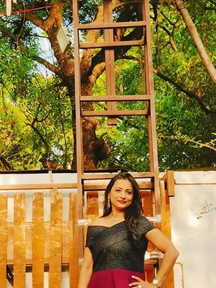 A moment of calm before hosting the baby naming ceremony in Pune. The beautiful outdoor setting with lush greenery provided a serene backdrop for this special family event.