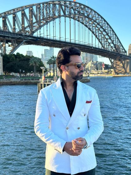 A closer look at the white double-breasted blazer, showcasing its sharp tailoring and crisp look.