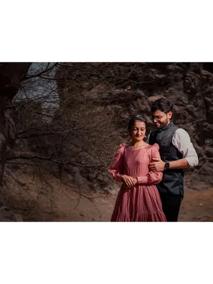 A quiet, romantic moment captured in a rustic, natural setting. The focus is on the couple's gentle interaction, away from everything else.