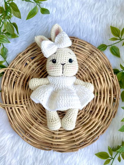 A pure white bunny doll, made as a special gift for a Holy Communion ceremony. Her simple white dress gives her a sacred and peaceful look.